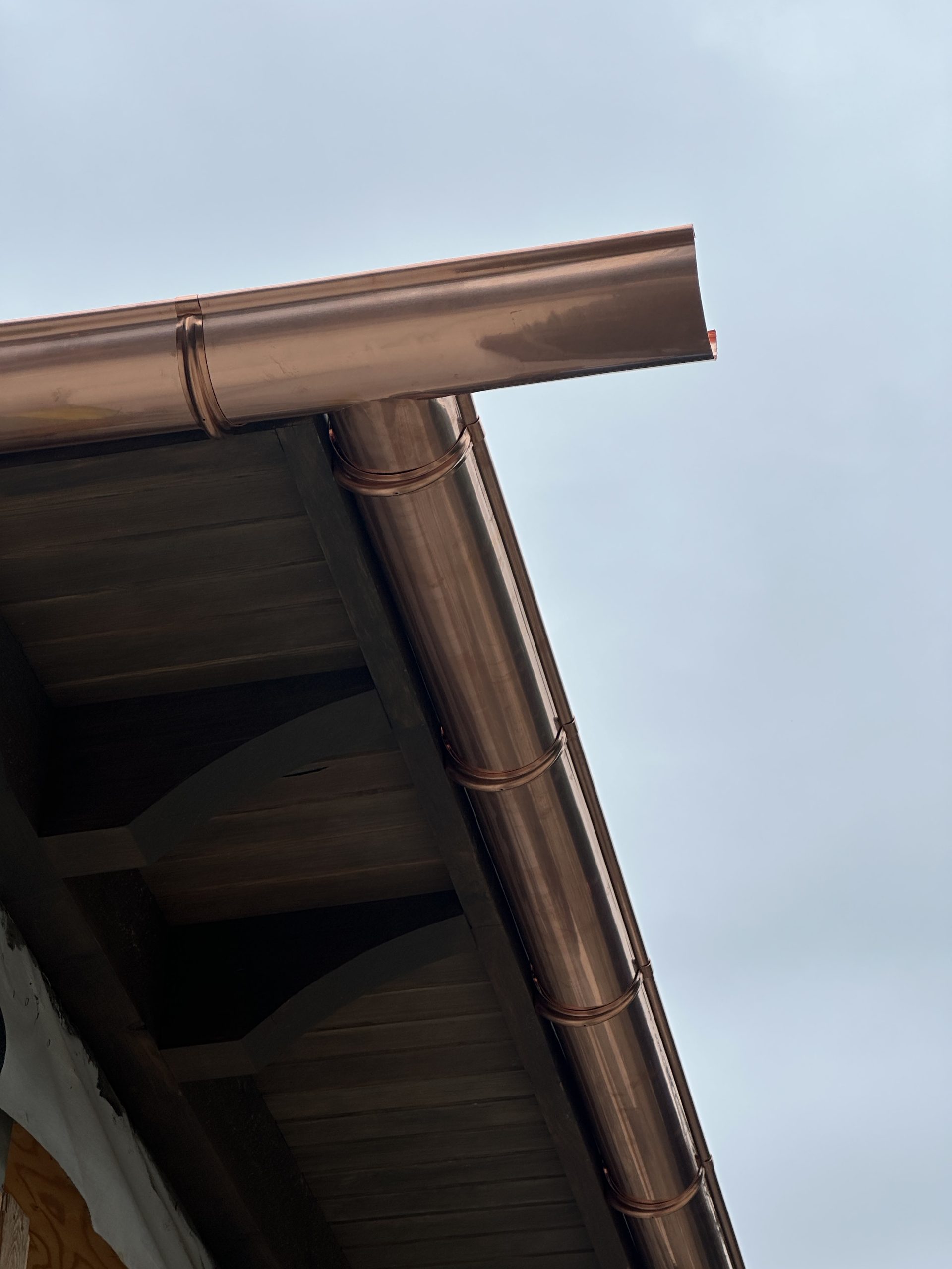 Copper eavestrough and fascia on a gabled roofline